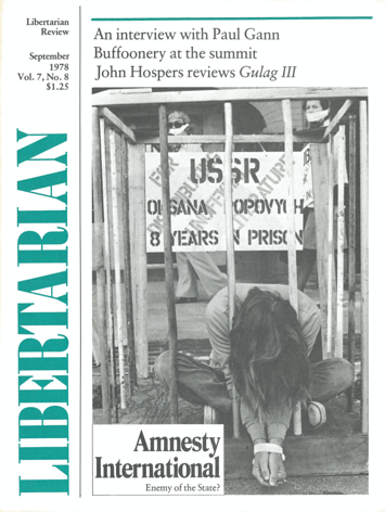 A person sits in a cage with their hands bound in front of them. The title reads: Amnesty International, Enemy of the State?