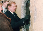 Vaclav Havel looks trough a hole of the Wall at the East side near Brandenburg Gate, Tuesday, January 02, 1990