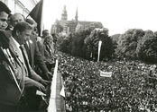 Havel stands on a balcony over a crowd of people.