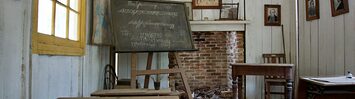 An old one room schoolhouse, in disrepair.