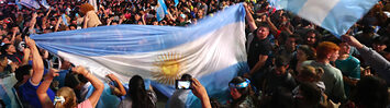 An Argentinian crowd waving flags in celebration of Milei's election.